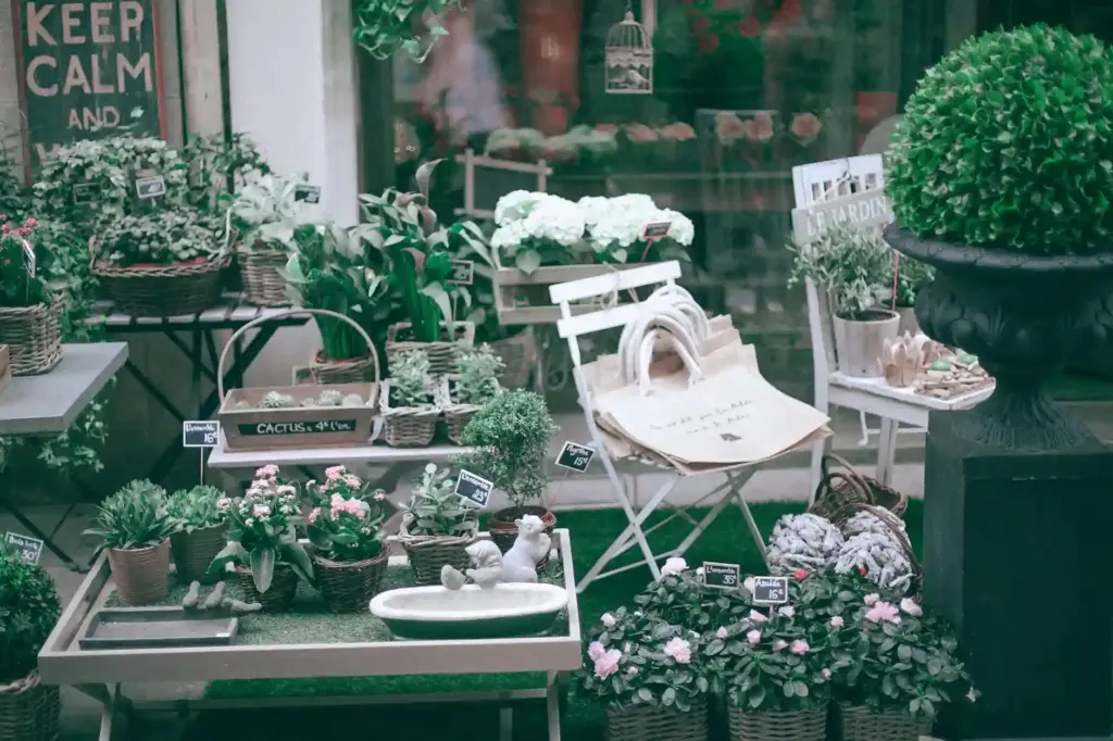 Explore a serene indoor plant shop showcasing lush greenery, floral decor, and elegant seating arrangements.