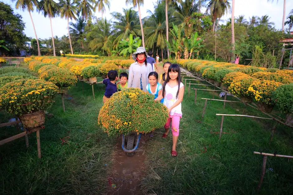 A happy family of children and an adult enjoying a sunny day in a lush flower garden.