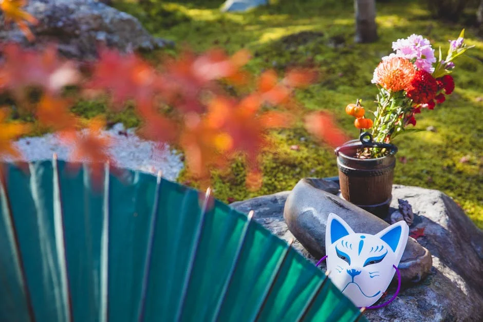 Serene Japanese garden scene featuring a kitsune mask and vibrant flowers on a sunny day.