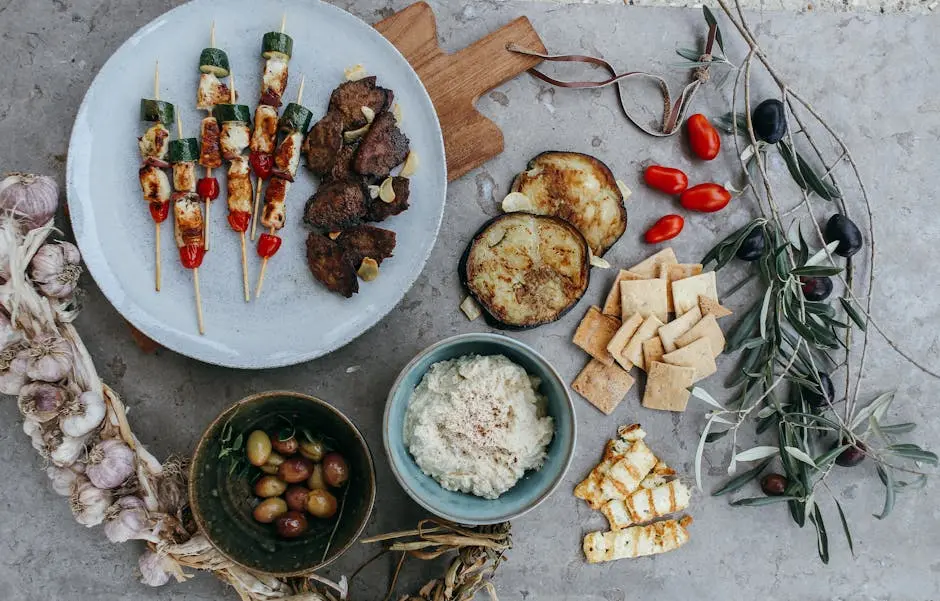 A Mediterranean appetizer spread featuring skewers, dips, and assorted veggies. Perfect for gatherings.