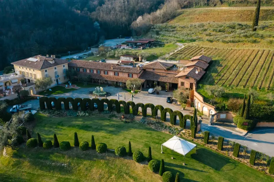 Aerial view of a beautiful vineyard estate with gardens and hills in Tuscany.