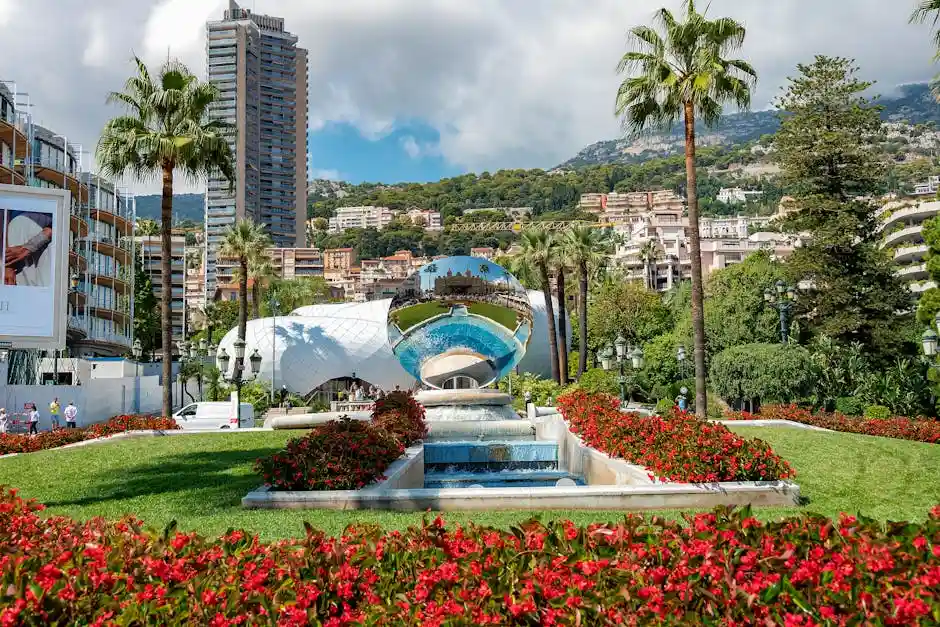 Vibrant summer view of Casino Square with palm trees and gardens in Monaco, featuring iconic landmarks.