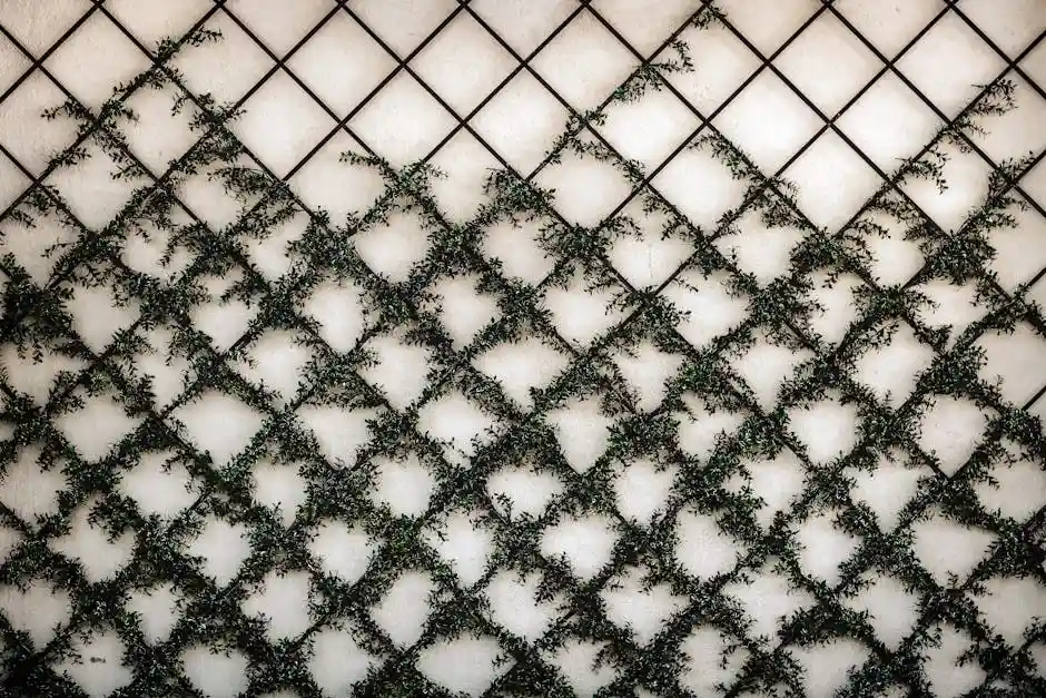 Artistic green vines climb a grid-patterned wall, creating a striking abstract design.