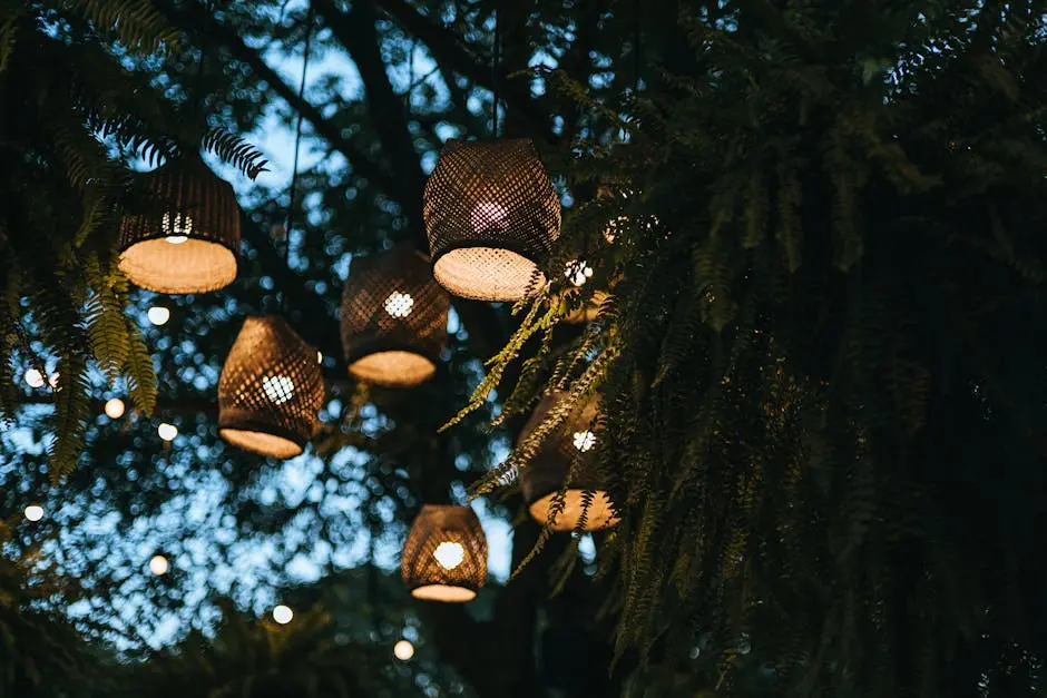 Hanging golden lanterns in a lush, evening garden create a magical ambiance.