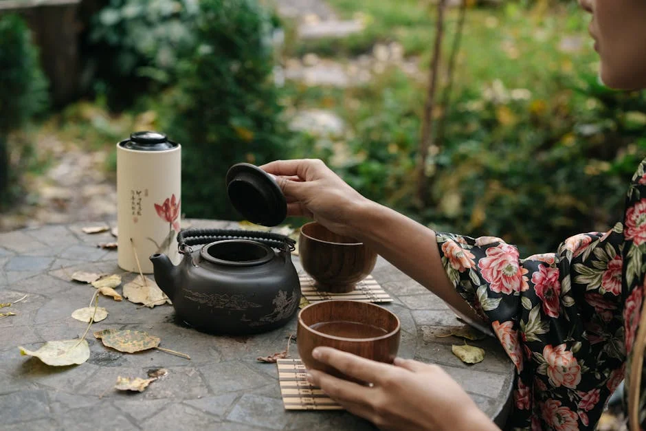 A serene Japanese tea ceremony outdoors with a woman in a floral kimono preparing tea.