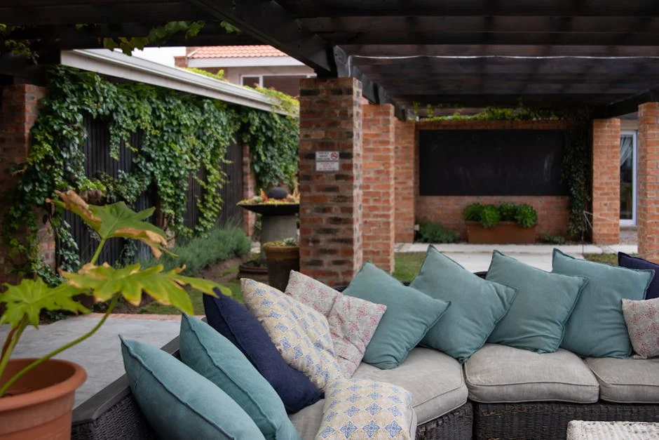 Comfortable outdoor seating with vibrant cushions and lush greenery, creating a cozy retreat.