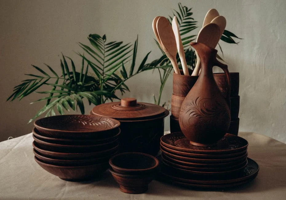 Rustic clay and wooden kitchenware arranged elegantly with natural decor.