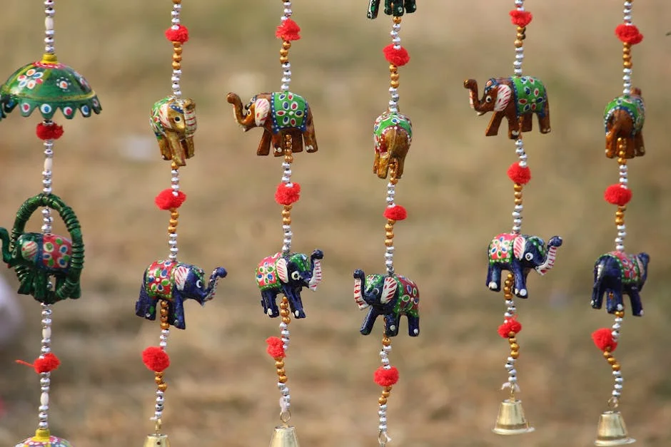Vibrant handcrafted elephant wind chimes with intricate beading, captured in Jaipur, India.