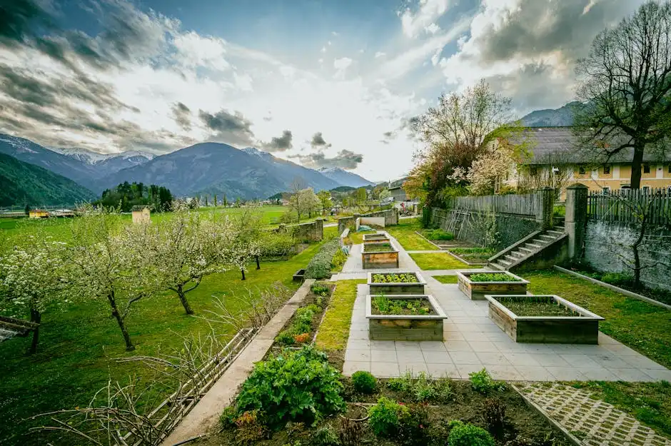 Lush spring garden with raised beds and mountain view in Lurnfeld, Carinthia, Austria.