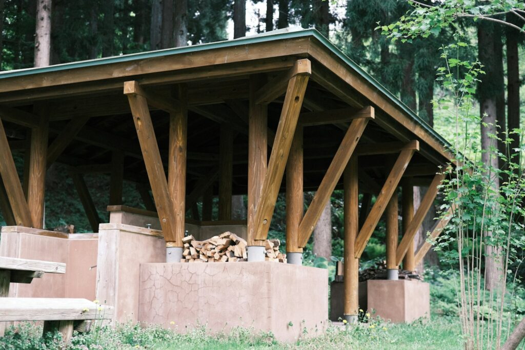 a wooden structure in the middle of a forest