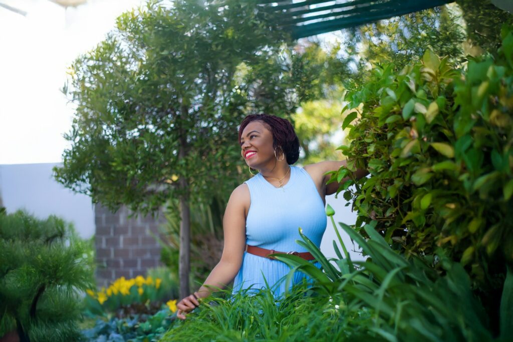 A woman in a blue dress standing in a garden