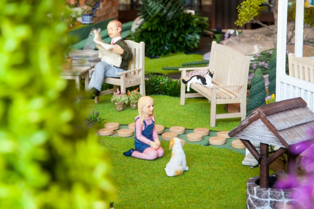 girl in blue dress sitting on brown wooden bench