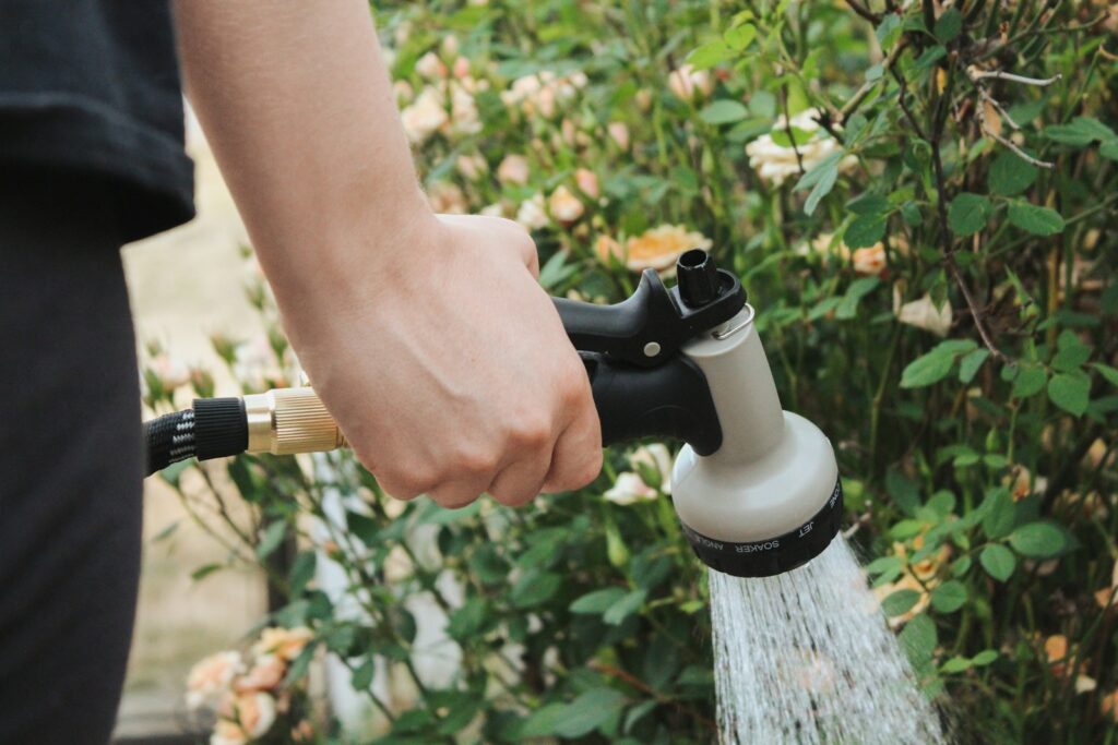 a person is holding a hose and spraying water