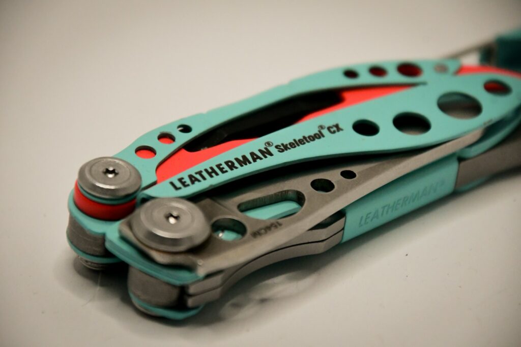 A pair of multi - tool with a red and blue handle