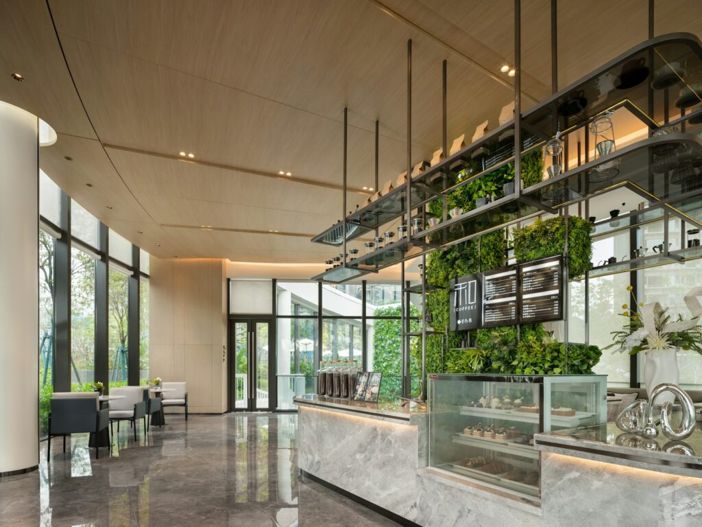 Modern cafe interior with plants and display counter
