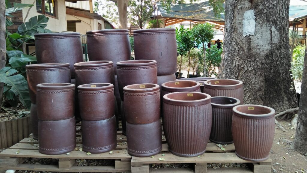 a pile of brown pots sitting on top of a wooden pallet