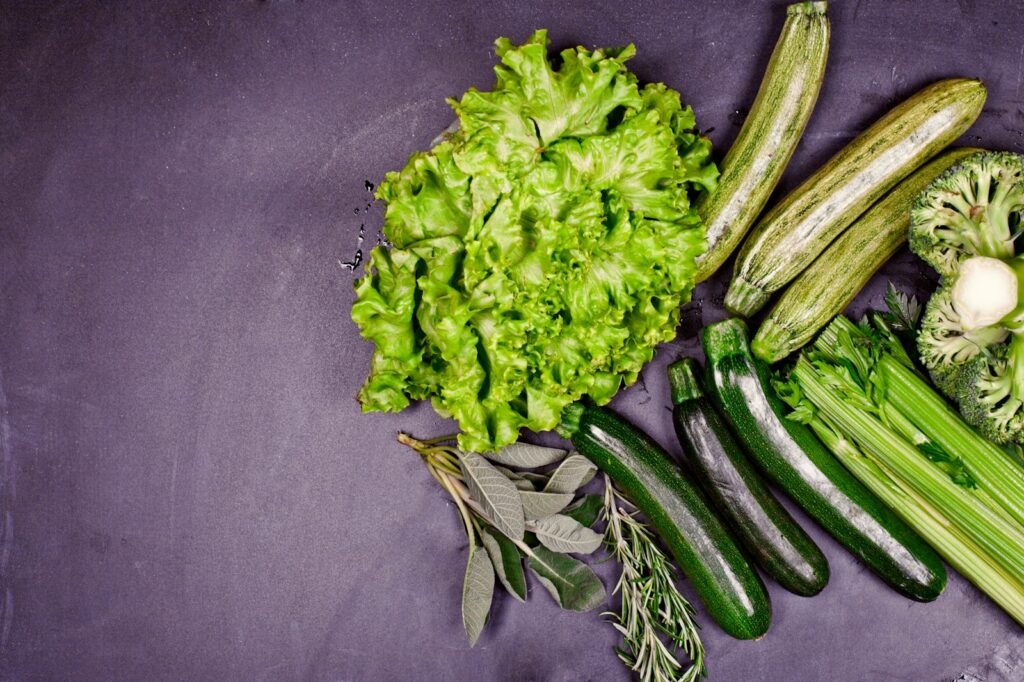 A group of vegetables sitting on top of a purple surface