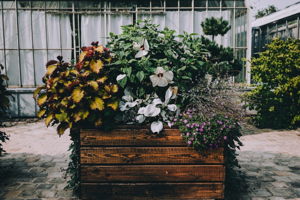 A wooden planter filled with lots of flowers