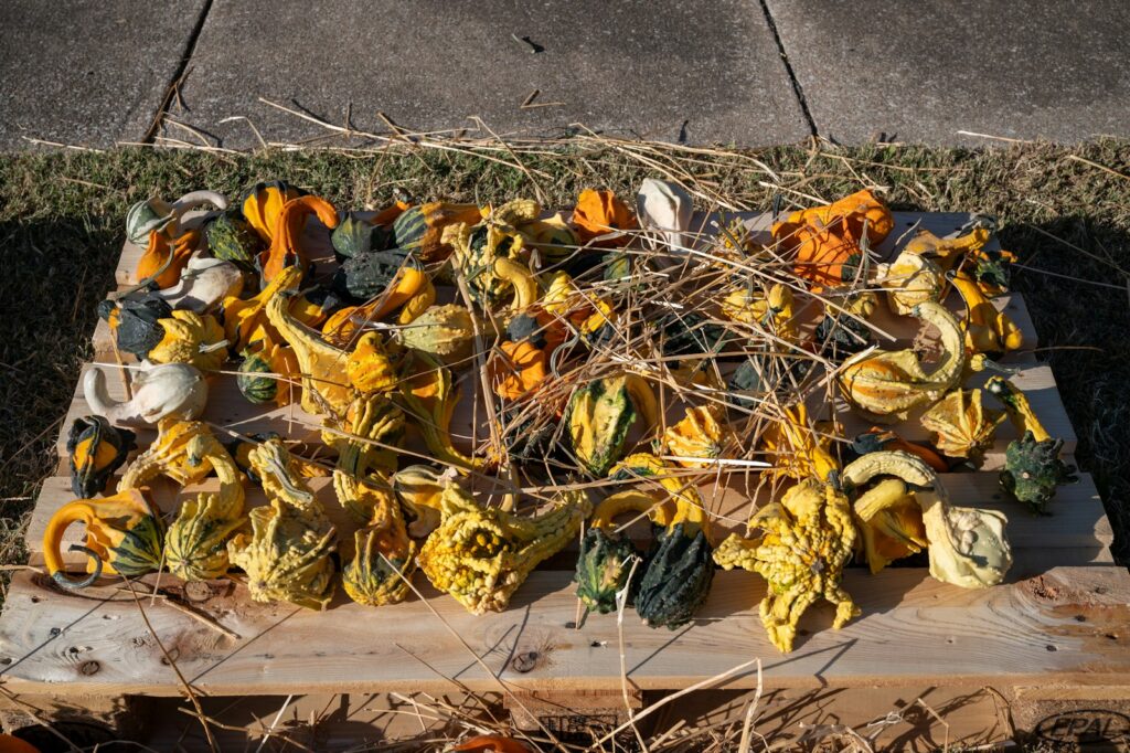 A pile of yellow flowers sitting on top of a wooden board