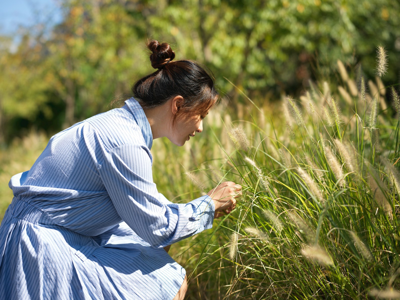 A woman in a blue dress standing in a field