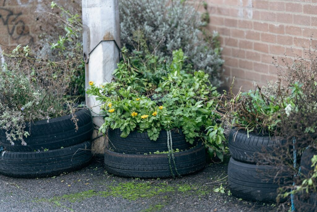 a bunch of tires sitting next to a brick wall