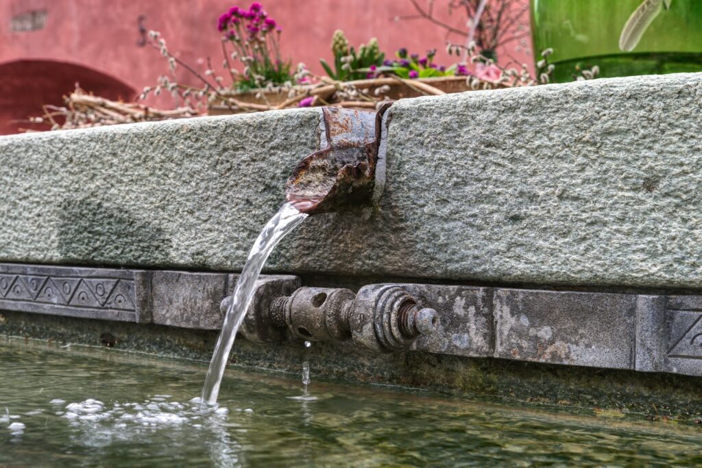a faucet running out of a water fountain