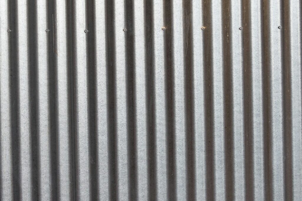 A close up of a metal wall with vertical lines