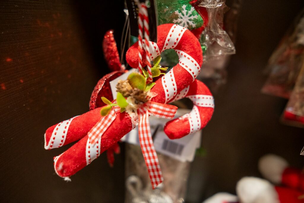 a red and white christmas decoration in a glass vase
