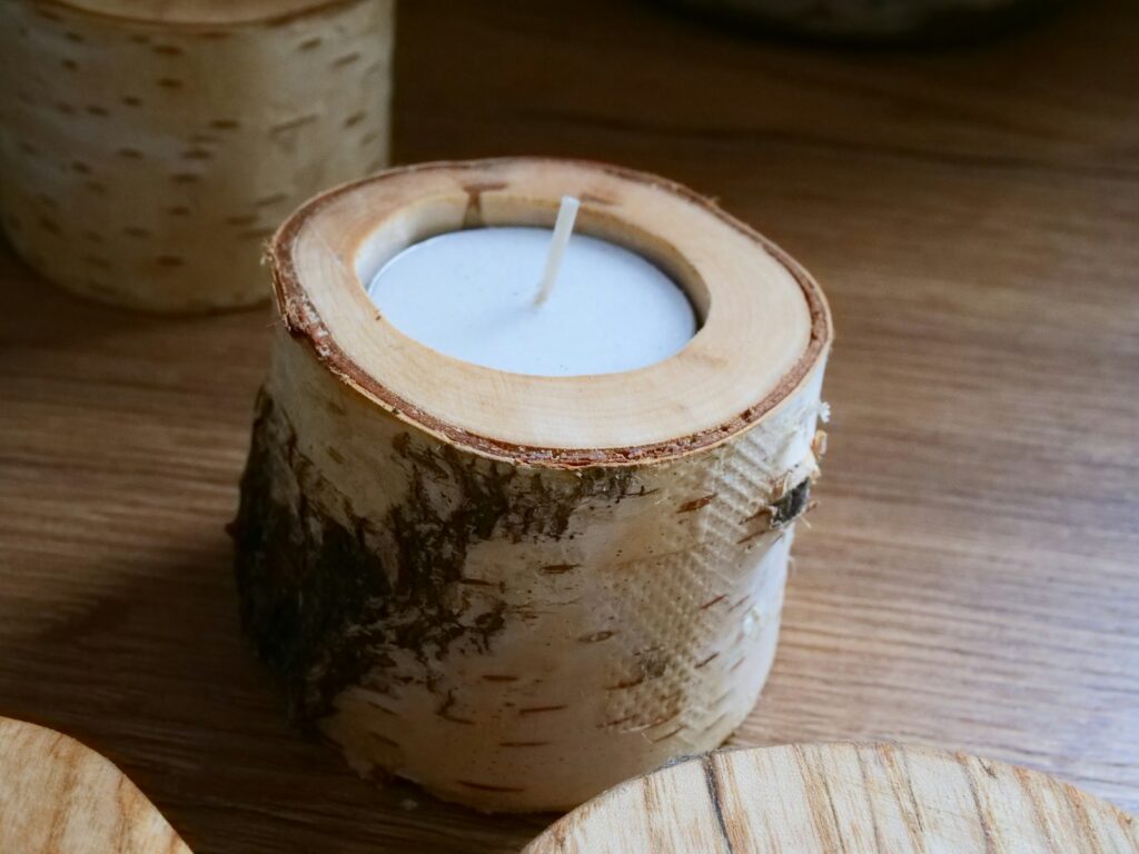 a wooden candle holder sitting on top of a wooden table