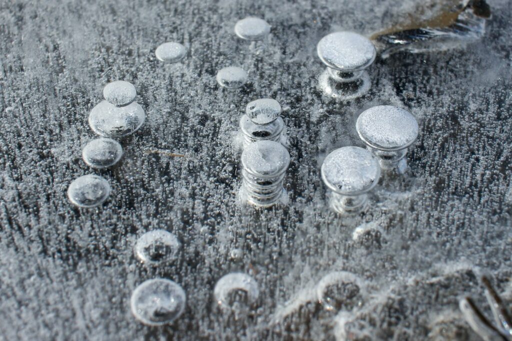 silver round coins on gray textile