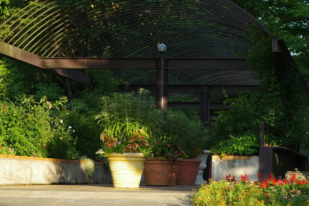 A bunch of potted plants in front of a gazebo