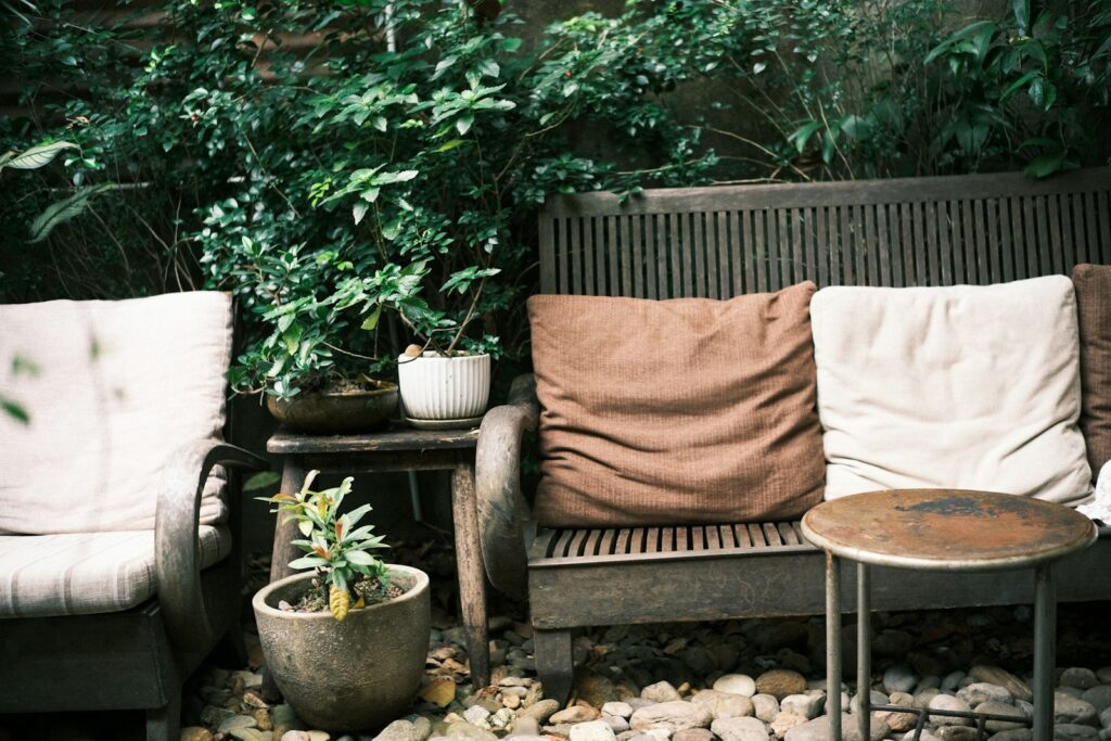 Cozy outdoor seating surrounded by lush greenery.