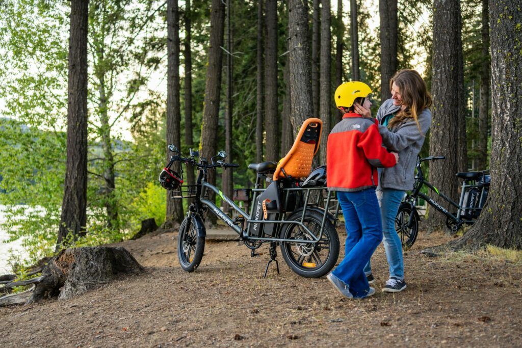 a couple of people standing next to a bike