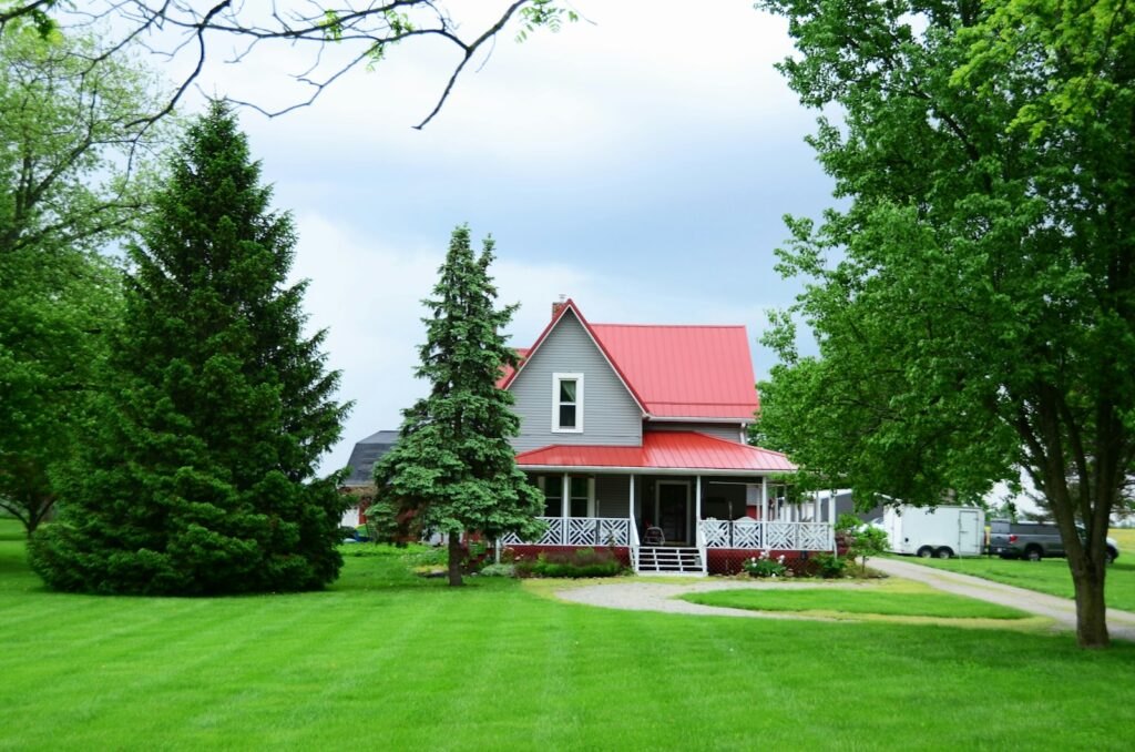a house with a red roof surrounded by trees