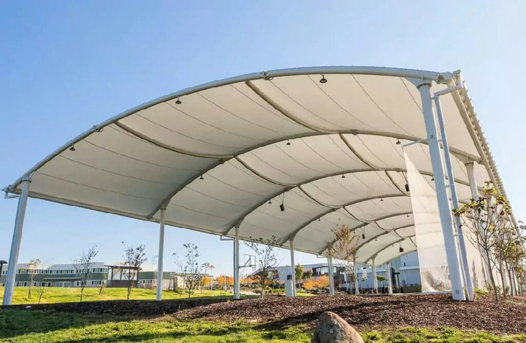 A white canopy provides shade in an open space.