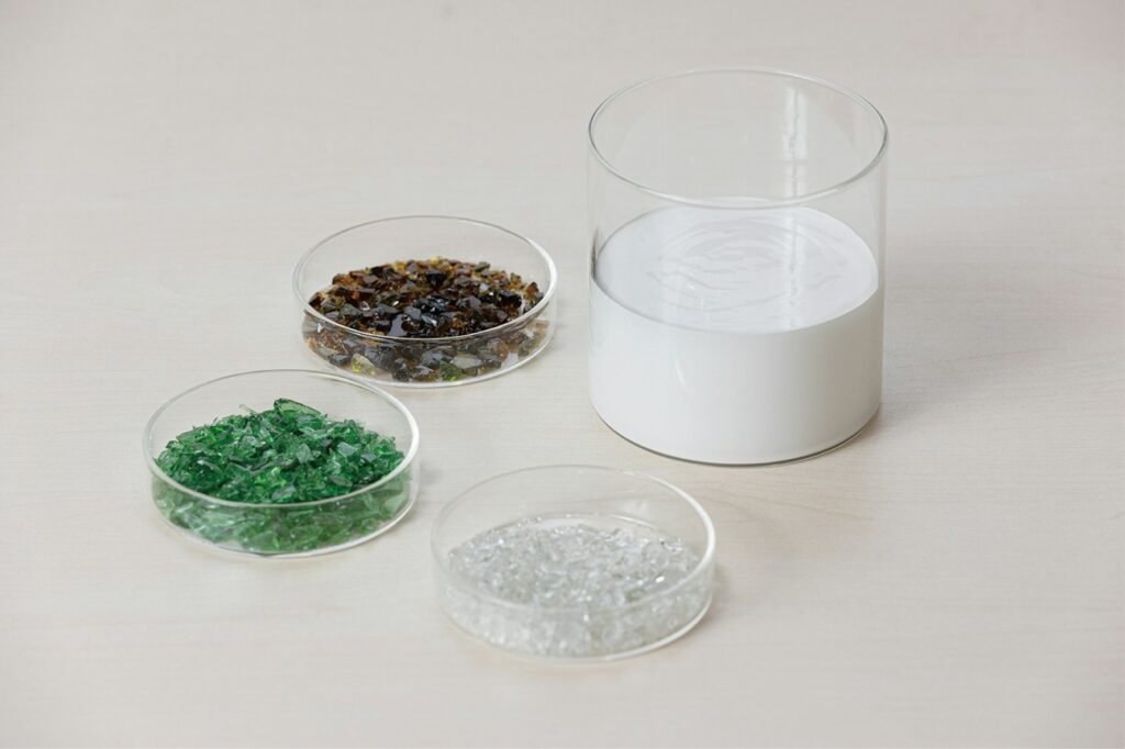 three bowls of different types of beads on a table