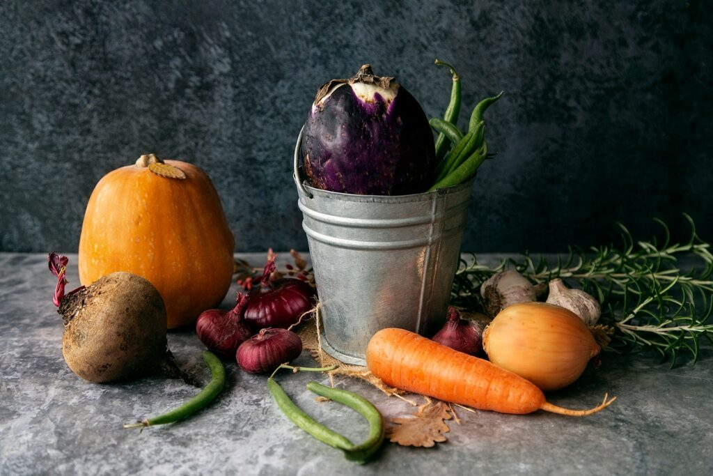 a group of vegetables and a jar