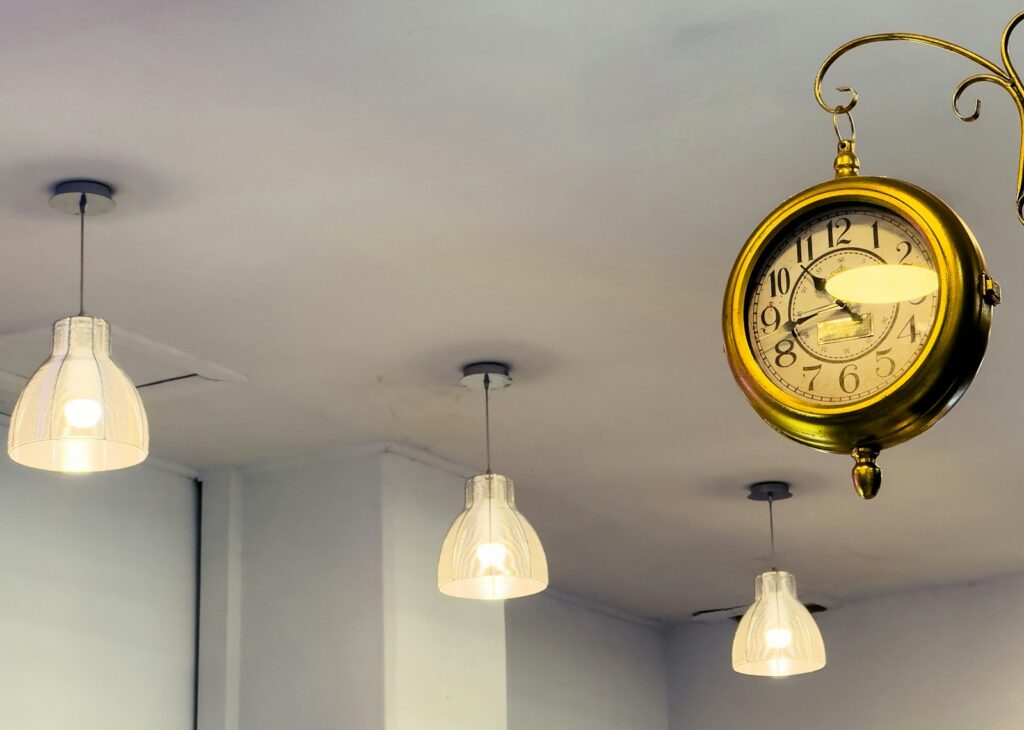 A clock hanging from the ceiling of a room