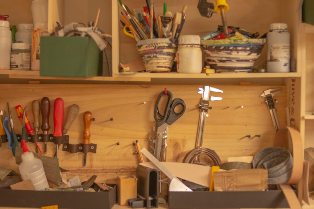 a wooden shelf filled with lots of tools