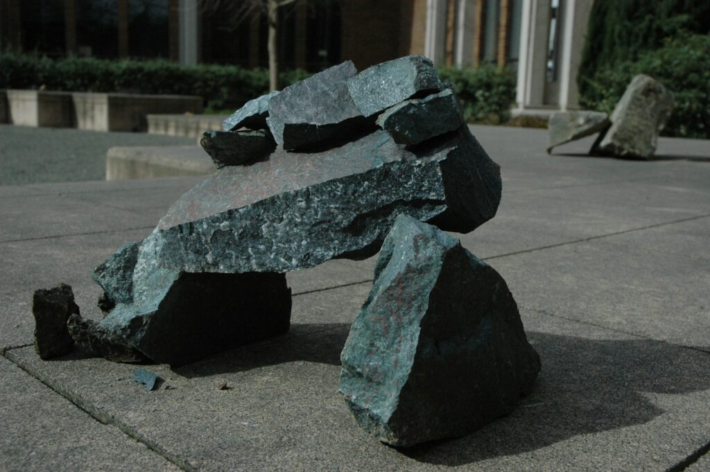 a large rock sitting on top of a sidewalk