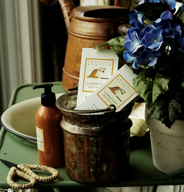 Aesthetic arrangement of gardening tools and blue hydrangea flowers on a rustic table.