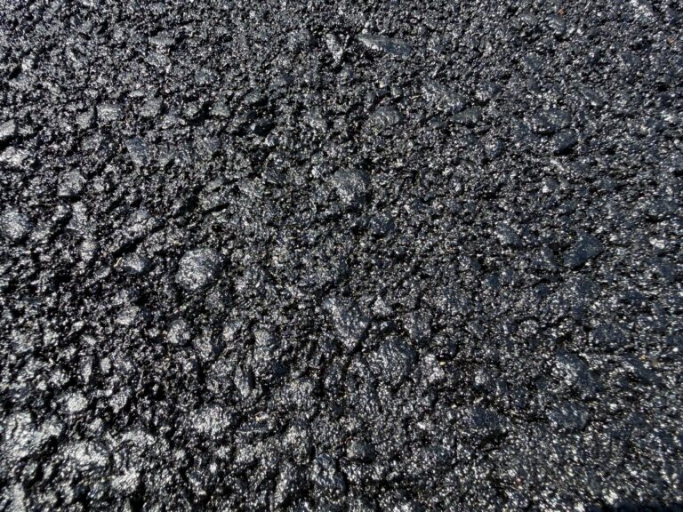 Fresh black asphalt on a newly paved residential driveway