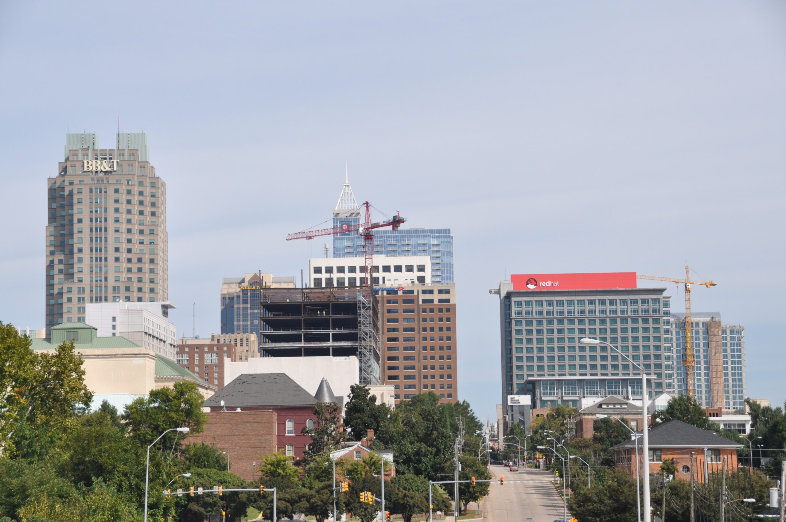 Raleigh, North Carolina skyline rising above a line of green trees