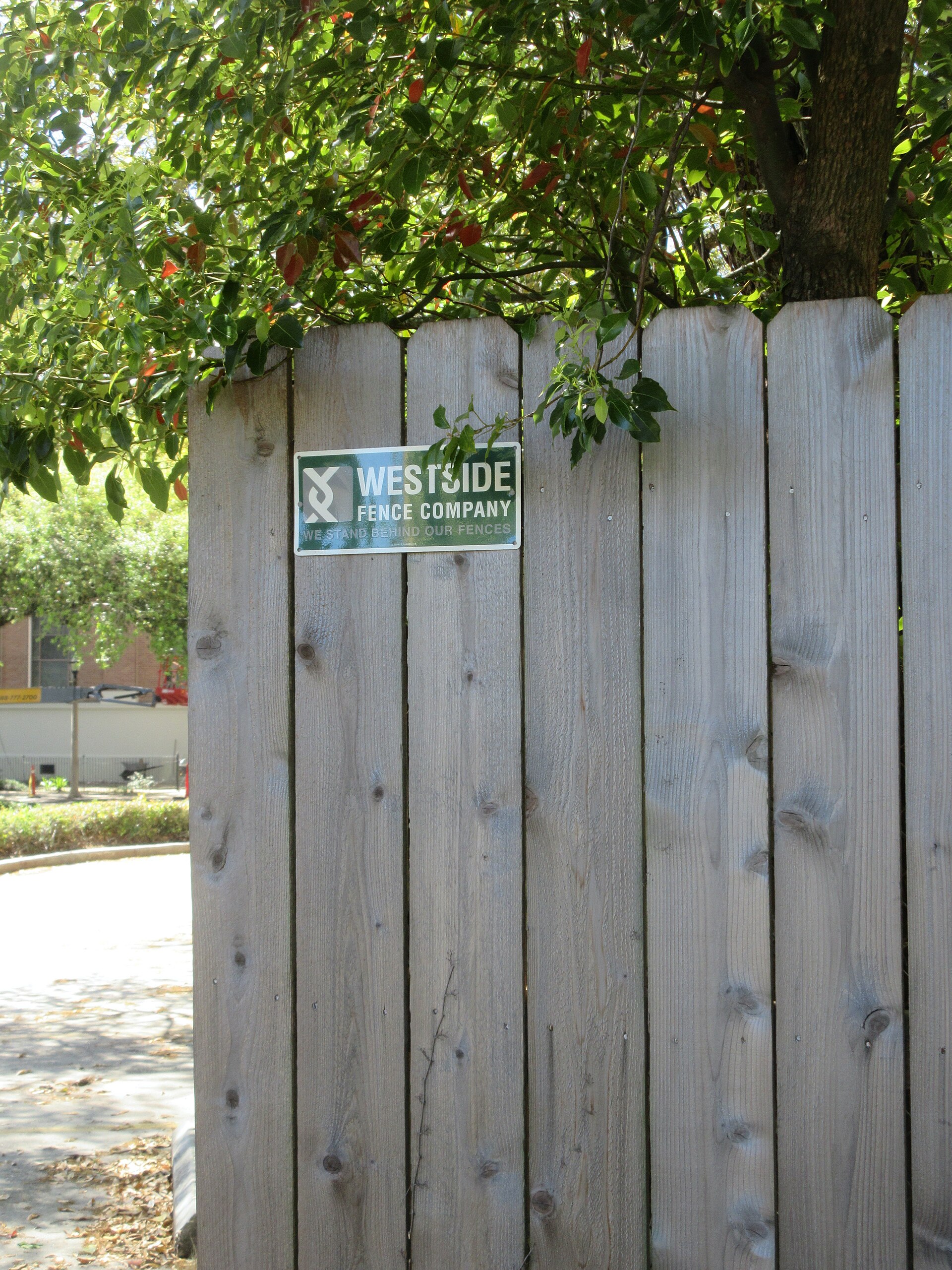 A weathered wooden privacy fence along a residential property line